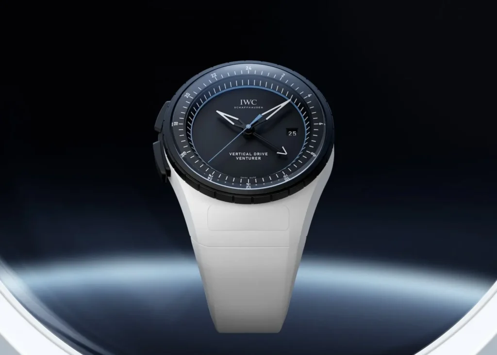 IWC Vertical Drive Venturer displayed against a dark futuristic background, emphasizing the contrast between the black dial and sculpted white case