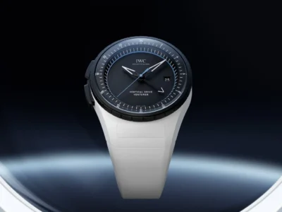 IWC Vertical Drive Venturer displayed against a dark futuristic background, emphasizing the contrast between the black dial and sculpted white case