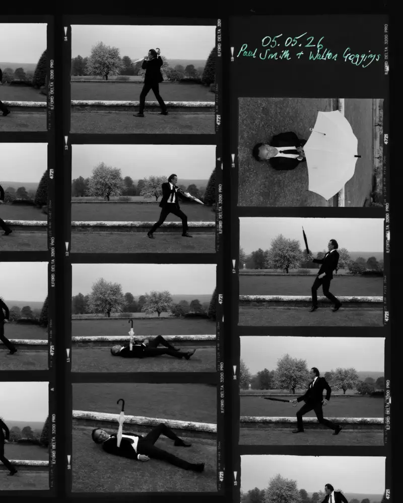 Contact-sheet style collage displaying multiple black-and-white frames from the editorial shoot. The subject performs playful poses with umbrellas and props, while handwritten text at the top references Paul Smith and Walton Goggins