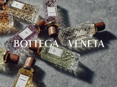 arranged across a stone surface, showcasing the range’s handcrafted bottles, wooden caps, and varied fragrance expressions