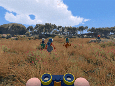 First-person view from a stylized adventure game showing a character holding binoculars while following a group of colorful explorers through a sunlit grassy field. Tall golden grass, pink wildflowers, scattered trees, and rocky hills stretch beneath a bright blue sky with large clouds, creating a whimsical outdoor journey atmosphere