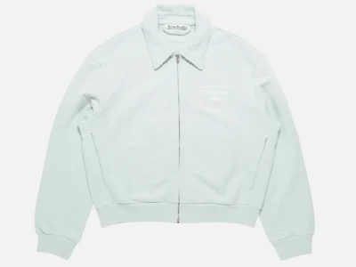 Front flat-lay view of the Acne Studios pale mint sweatshirt jacket featuring a full zip closure, pointed collar, ribbed hem and cuffs, oversized silhouette, and minimalist brand