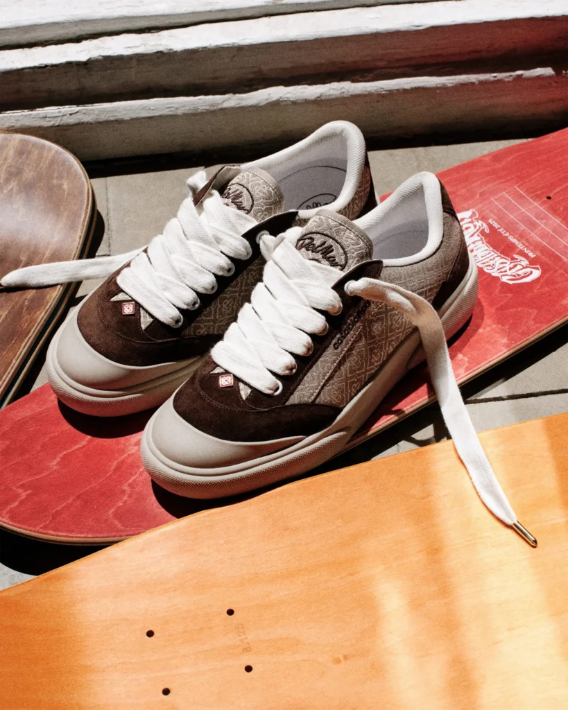 Brown monogram Casablanca Del Mar shoe resting across vintage skateboard decks, combining textured jacquard uppers, dark suede details, and thick rope-style laces in a skate-inspired set