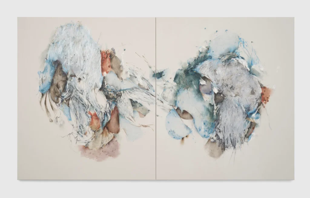 Abstract diptych painting featuring layered mixed-media textures in soft blue, white, gray, and muted earth tones. Two organic, cloud-like compositions face each other across a central divide, blending expressive brushwork, delicate linework, and translucent washes. Feathery textures, gestural marks, and fragmented forms create a sense of movement, transformation, and atmospheric depth against a minimalist off-white background