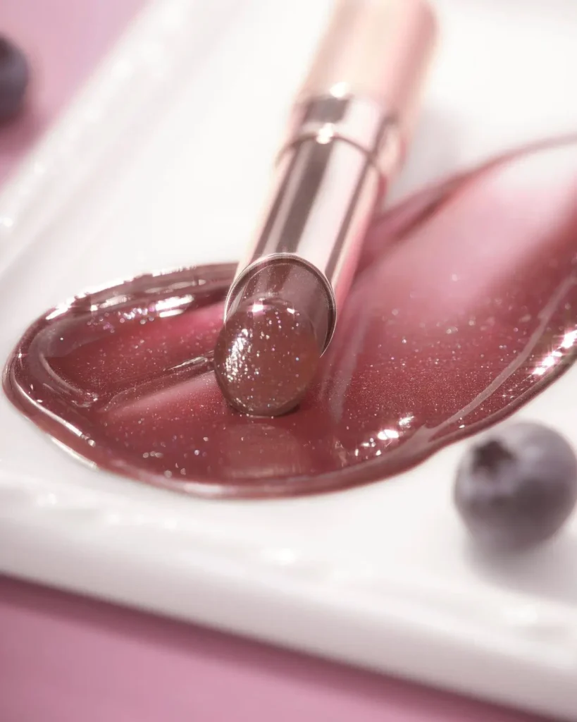 OPERA Bordeaux Brown lip tint close-up swatch with juicy Rose Jam texture and glitter, deep autumn berry shade