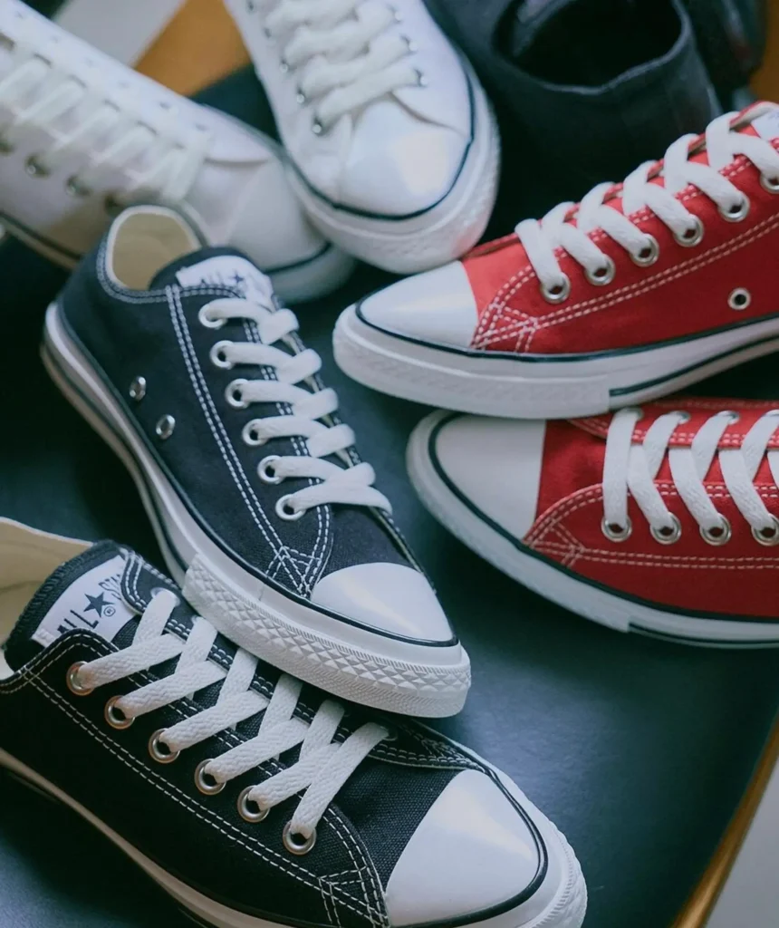 Assorted Converse Chuck Taylor shoe in black, white, and red colorways arranged together, highlighting the collection’s versatile styling option