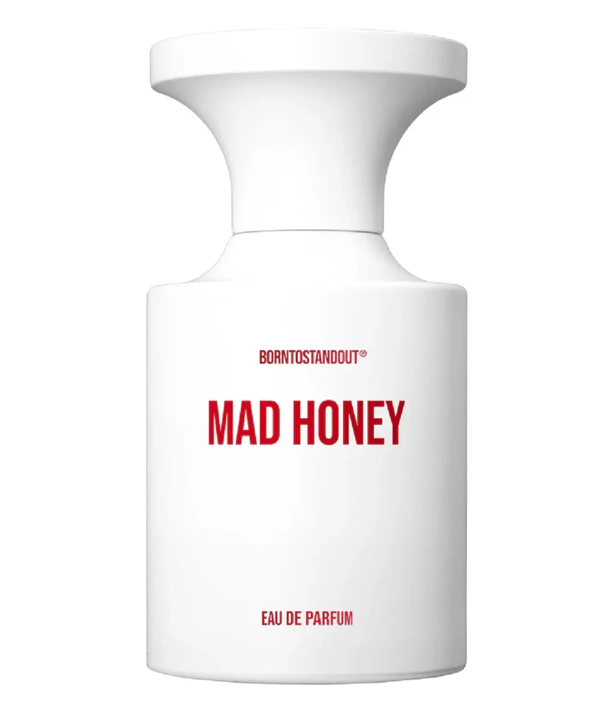 Minimalist white perfume bottle labeled “MAD HONEY” by BORNTOSTANDOUT®. The matte white flacon features a sculptural, oversized cap with bold red typography, creating a striking contrast against a clean light-gray background