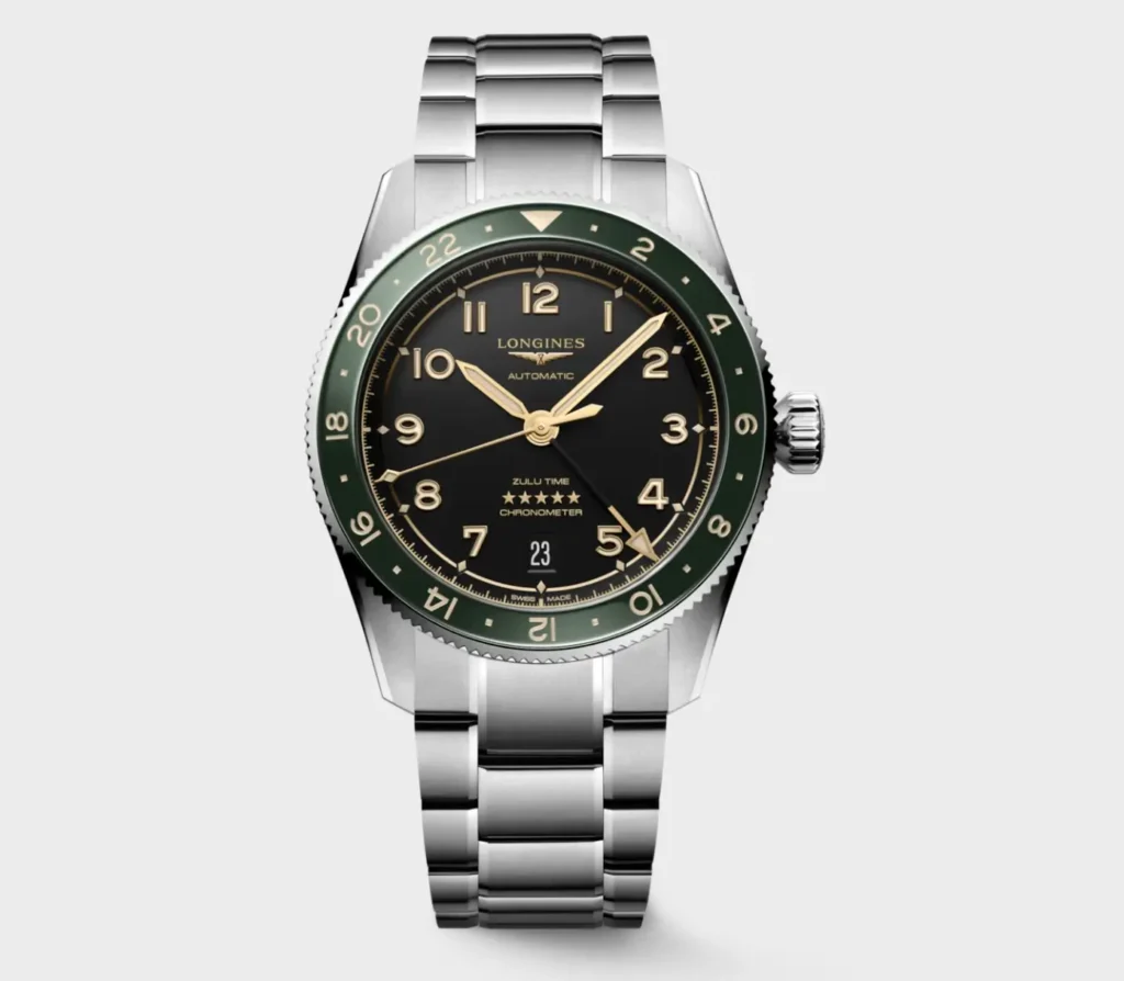 Front-facing product shot of the Longines Spirit Zulu Time GMT watch featuring a polished stainless steel bracelet, black dial with gilt-tone Arabic numerals, and a green ceramic 24-hour bezel. The compact 39mm case emphasizes the vintage-inspired pilot watch design while maintaining a refined, contemporary look