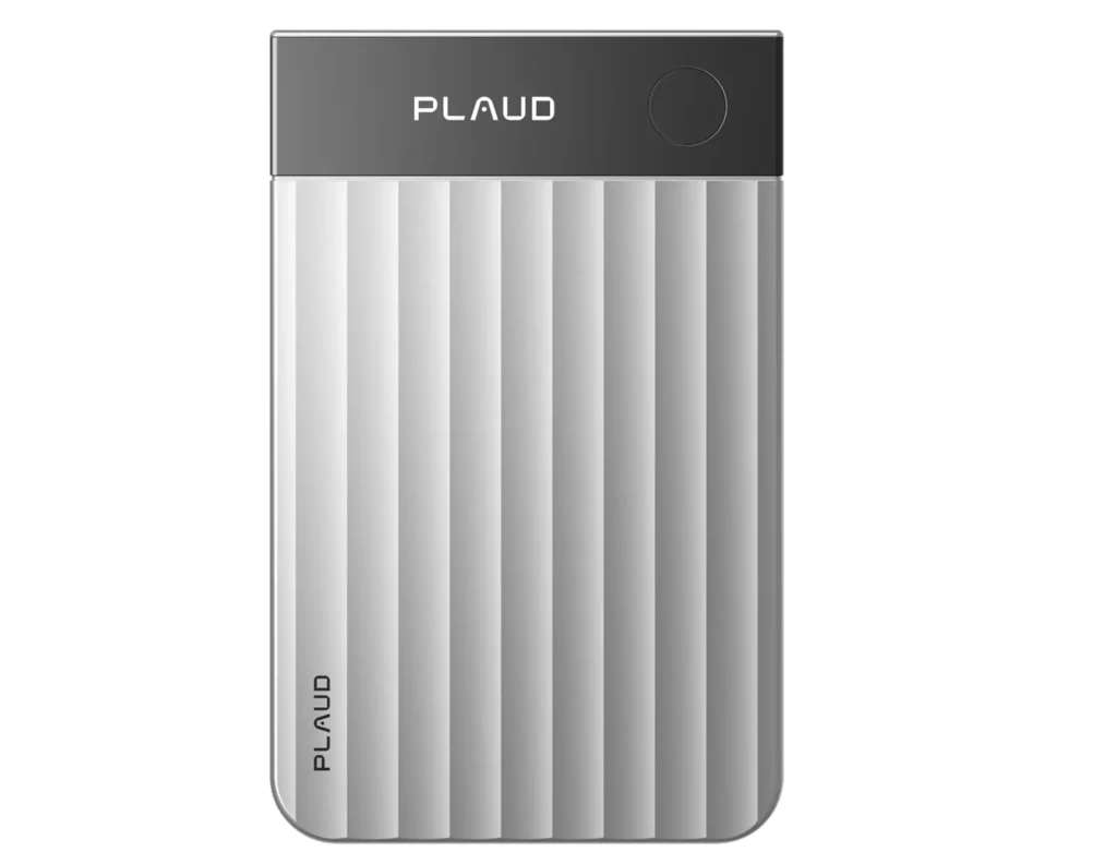 A silver PLAUD AI voice recorder with a vertically ribbed aluminum body, black top panel, circular button, and minimalist branding displayed against a white background