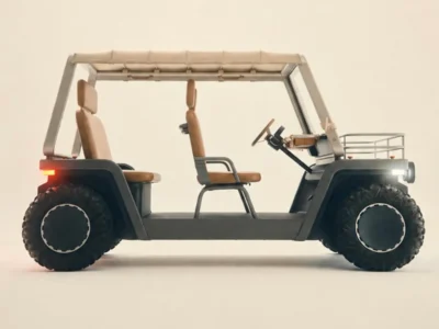 Side profile of a minimalist open-air electric utility vehicle with a rugged, boxy design. The vehicle features a light beige tubular frame, matching fabric canopy roof, tan leather-look seats, exposed steering column, and large off-road tires with black wheel covers. LED headlights and rear lights are illuminated, while a small cargo rack sits above the front hood. The concept vehicle is photographed against a clean cream-colored studio background, emphasizing its modern industrial aesthetic and functional design