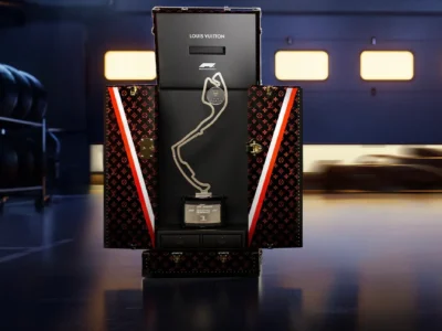 Louis Vuitton Formula 1 Trophy Trunk opened to reveal the championship trophy presentation inside a professional racing garage environment