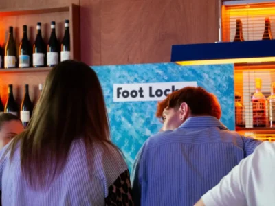 Guests gather in front of the Foot Locker branded backdrop at Frisson, Pigneto, during the exclusive Pair Up for Summer soft clubbing event in Rome
