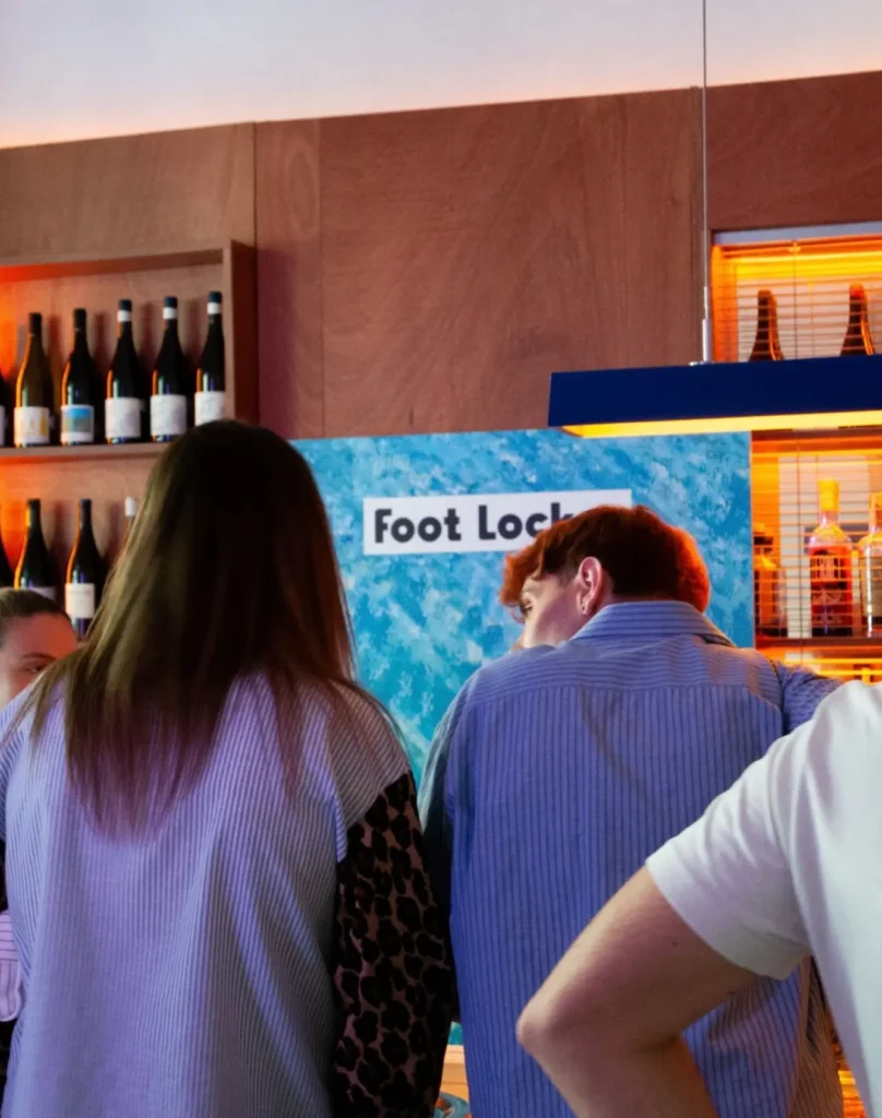 Guests gather in front of the Foot Locker branded backdrop at Frisson, Pigneto, during the exclusive Pair Up for Summer soft clubbing event in Rome