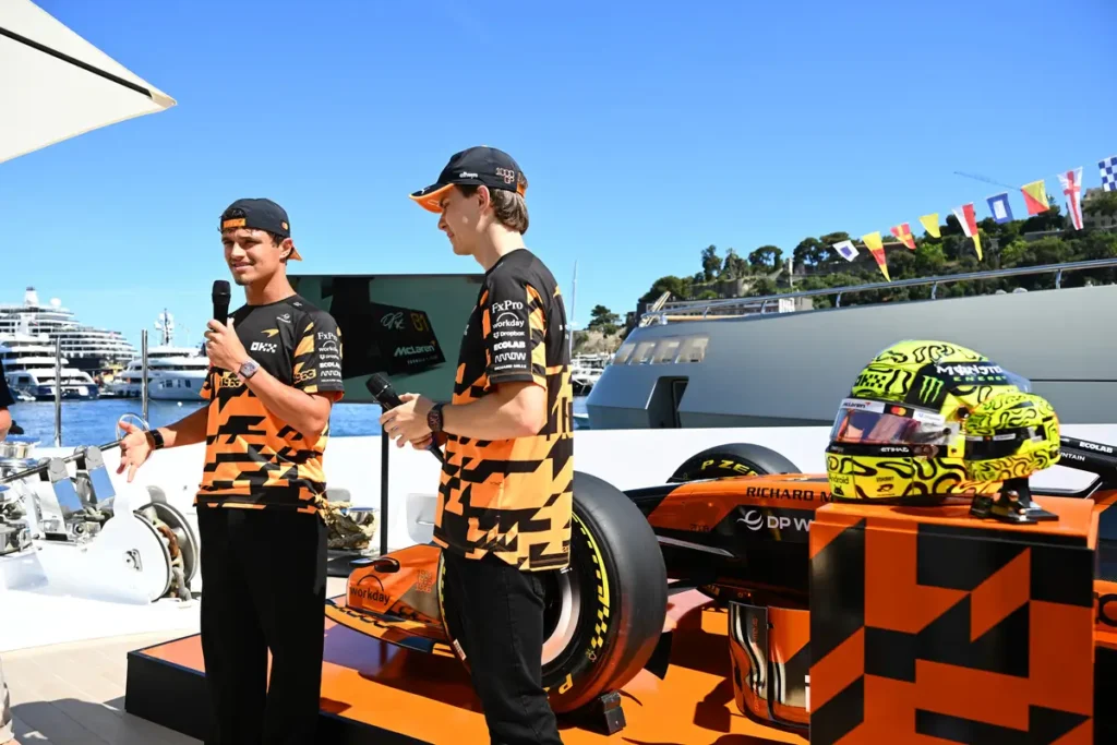 Detailed display of full-size McLaren racing helmets and matching LEGO helmet replicas, highlighting the accuracy of the brick-built collector models