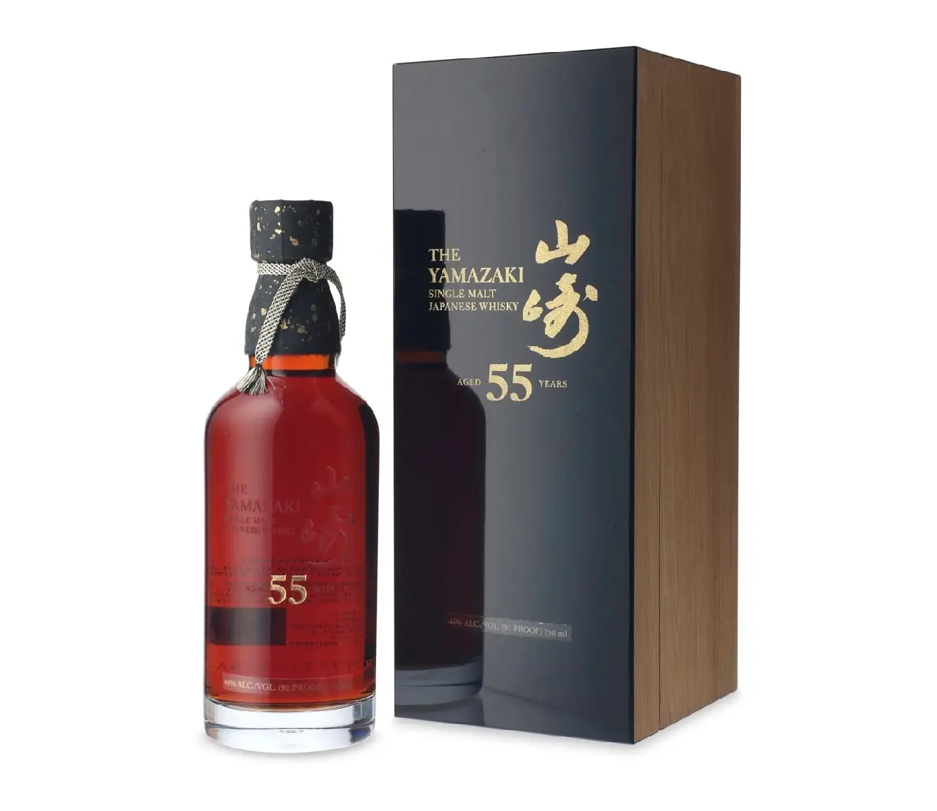 The Yamazaki 55 Years Old Single Malt Japanese Whisky displayed beside its luxury presentation box. The bottle showcases a rich mahogany-amber spirit, gold-embossed branding, and a handcrafted gold-flecked stopper, while the glossy black and wood-grain box highlights the exclusive aged expression