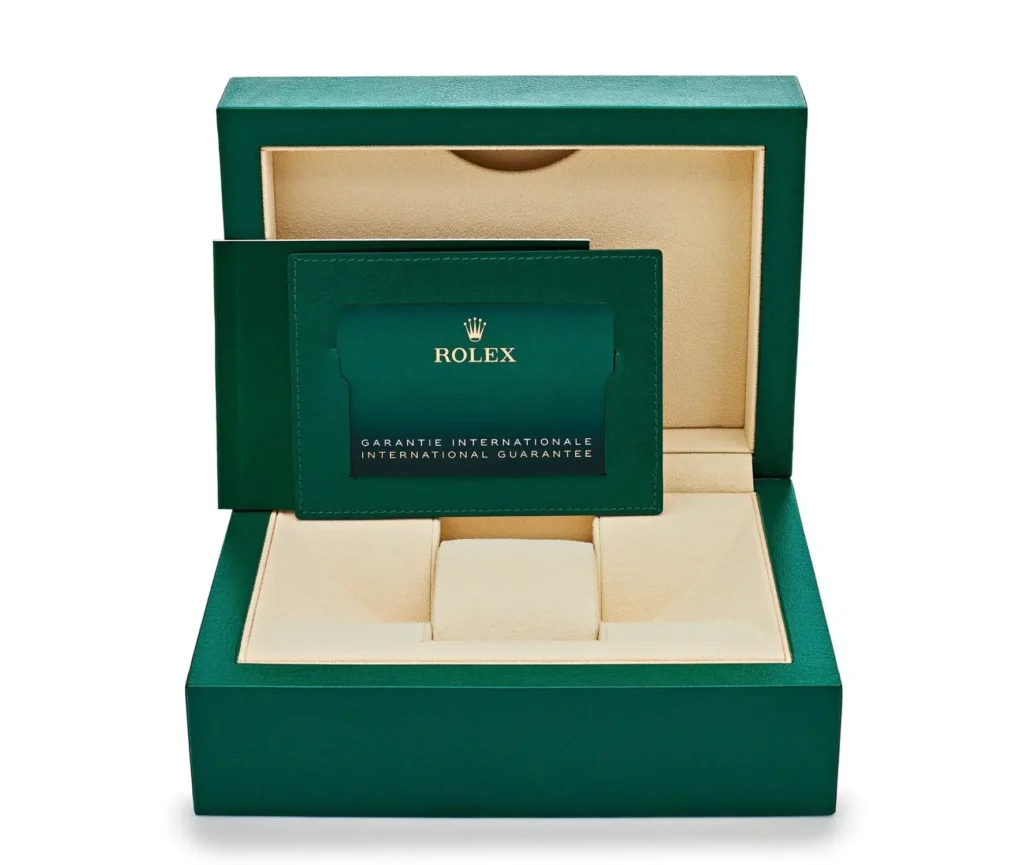 Official Rolex presentation box with international guarantee booklet and documentation, shown alongside the haute watch packaging