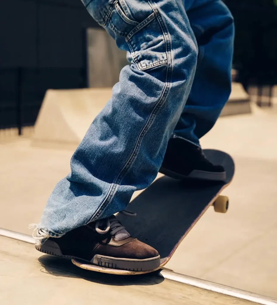 A skater mid skate move while wearing the brown colorway, demonstrating the collection’s performance-driven roots and community-focused campaign aesthetic