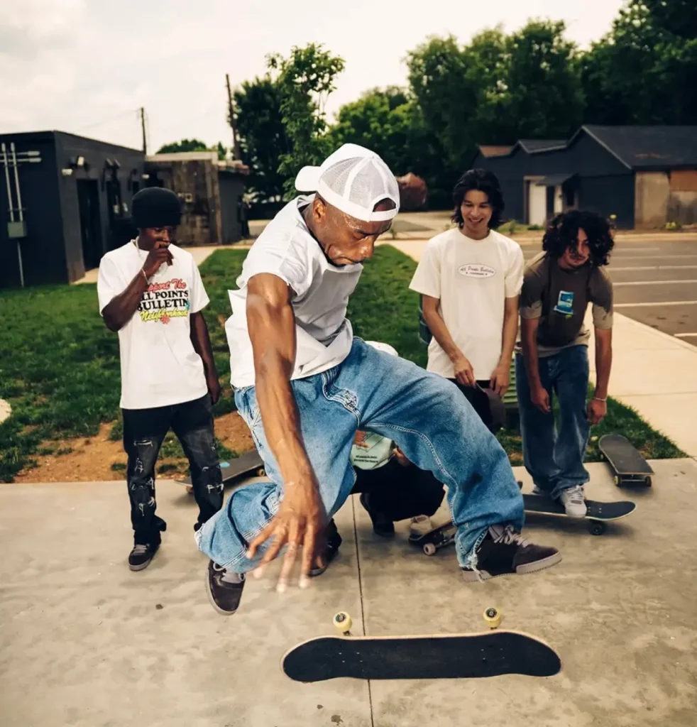 Group campaign imagery captures skaters gathered around a trick session, with multiple pairs of the Powerphase “Puff” view throughout the scene