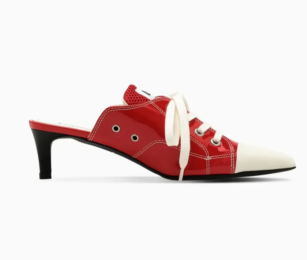 Opposite side profile highlighting the mule’s open-back construction, silver ventilation eyelets, glossy red upper, cream laces, and curved black kitten heel