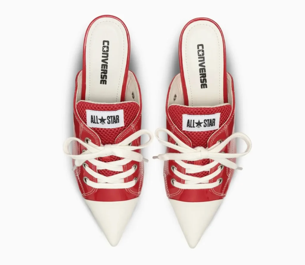 Top-down view of the footwear pair revealing Converse branding on the insoles, mesh tongue construction, oversized lace bows, and elongated pointed toe design