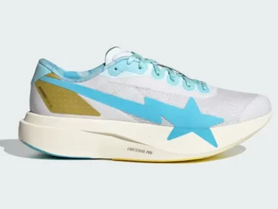 The adidas Adizero Evo SL x BAPE appears in white engineered mesh with a large sky-blue shooting star logo, metallic gold heel overlay, Lightstrike Pro midsole, and pastel blue lace