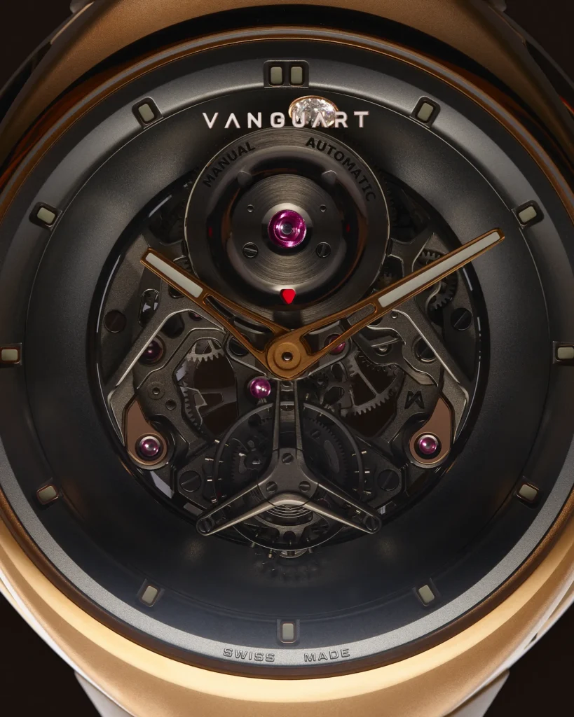 Extreme close-up of the Vanguart watch dial showcasing its open-worked mechanical movement, exposed gears, ruby jewels, and sculptural hands framed by a dark circular chapter ring