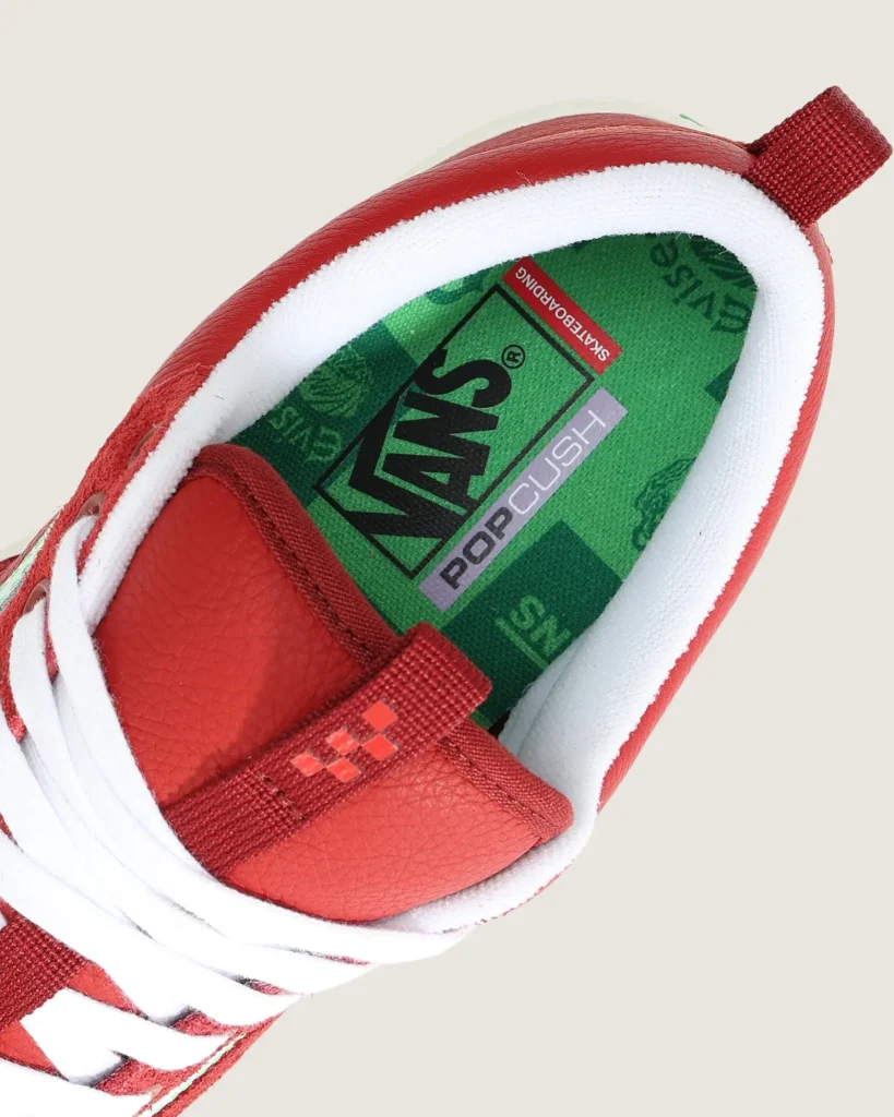 Close-up of the shoe interior revealing the green Vans PopCush insole with Evisen Skateboards-inspired graphics and co-branded detail