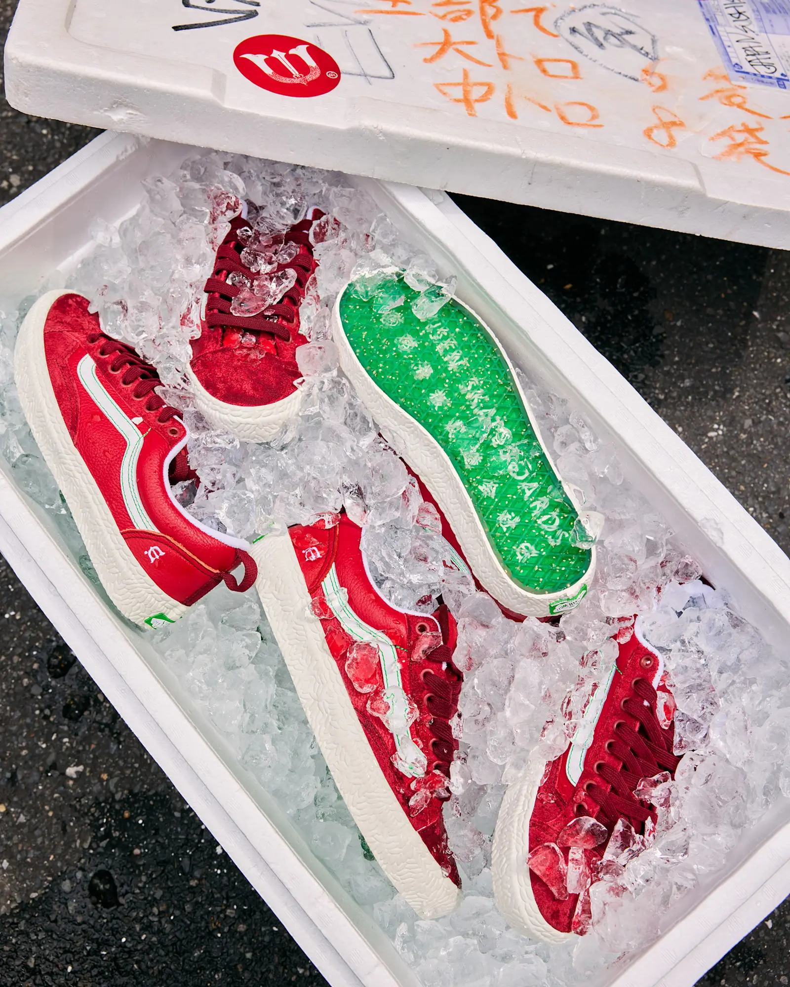 Multiple pairs of the Vans x Evisen Skate Old Skool 36+ arranged inside a fish-market-style ice crate, emphasizing the merge play seafood-market theme