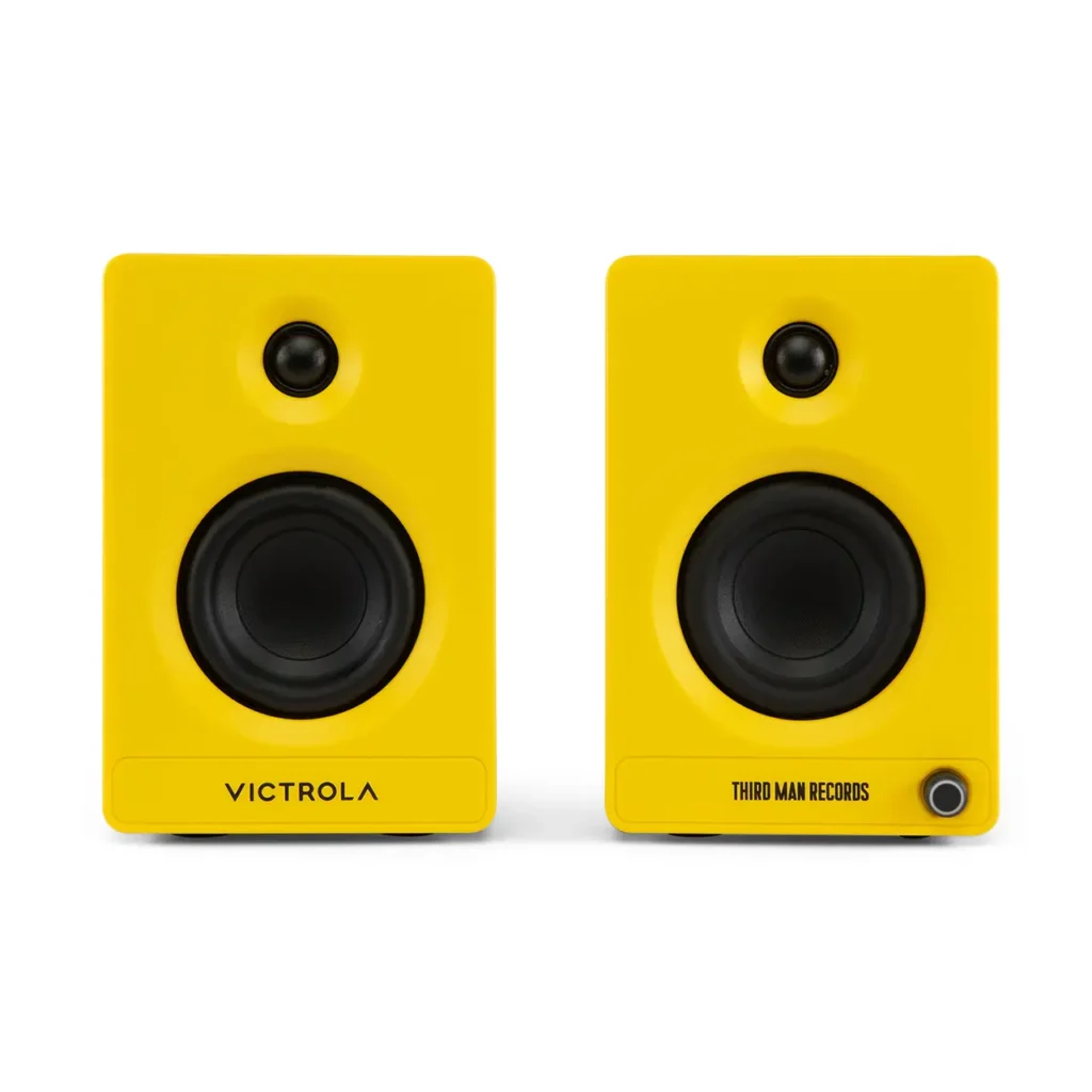 Front view of the Victrola x Third Man Records Tempo bookshelf speakers in signature bright yellow, featuring black tweeters and woofers with co-branded logos across the lower front panel