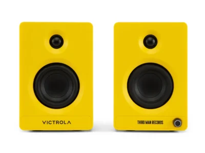 Front view of the Victrola x Third Man Records Tempo bookshelf speakers in signature bright yellow, featuring black tweeters and woofers with co-branded logos across the lower front panel