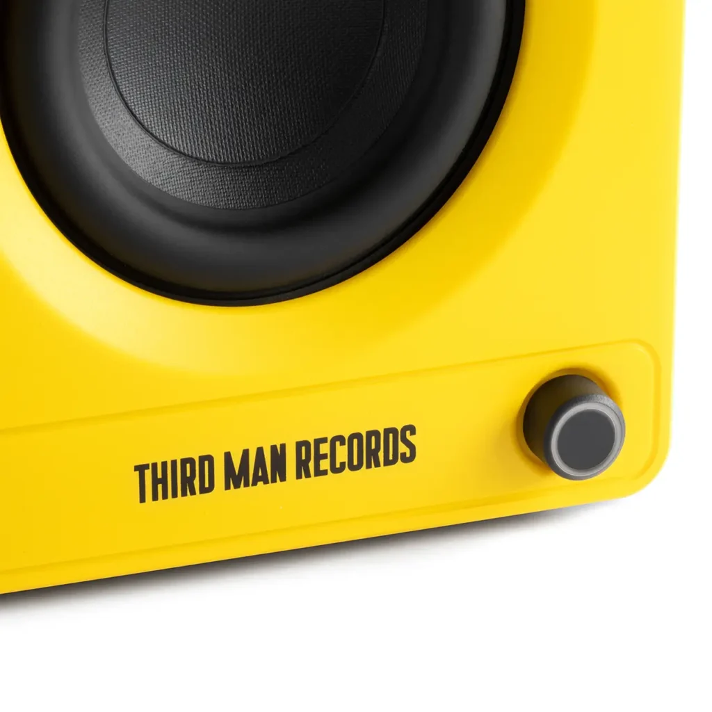 Close-up detail of the powered speaker from the Victrola x Third Man Records collaboration, focusing on the textured woofer, co-branded logo, and volume control knob