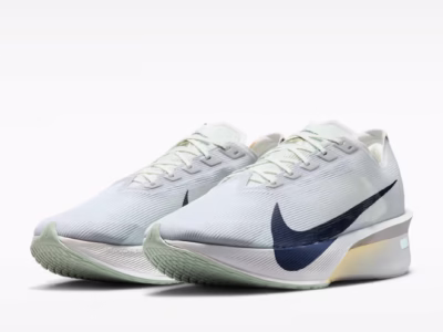 Angled front view of a pair of Nike ZoomX Vaporfly NEXT% 4 shoes showcasing breathable translucent uppers, oversized black Swooshes, mint-green outsole edges, and responsive ZoomX midsoles built for marathon race
