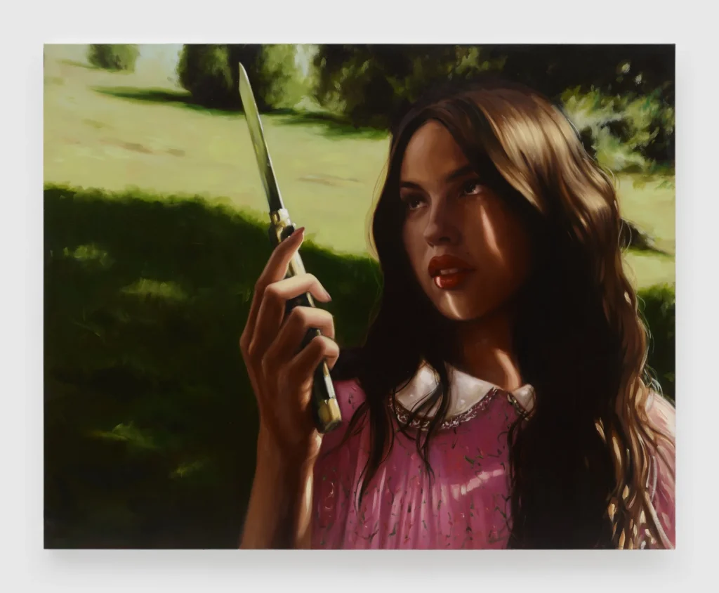 A large oil painting depicts a young woman standing outdoors in a sunlit landscape while holding a knife upright in one hand. Strong contrasts of light and shadow, deep green surroundings, and expressive brushwork give the portrait a dramatic and atmospheric quality