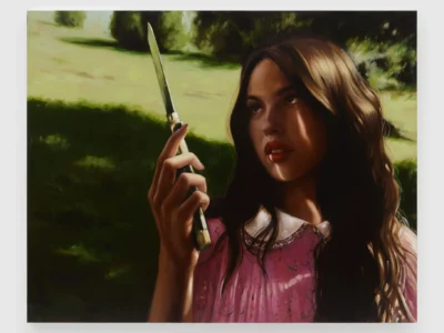 A large oil painting depicts a young woman standing outdoors in a sunlit landscape while holding a knife upright in one hand. Strong contrasts of light and shadow, deep green surroundings, and expressive brushwork give the portrait a dramatic and atmospheric quality