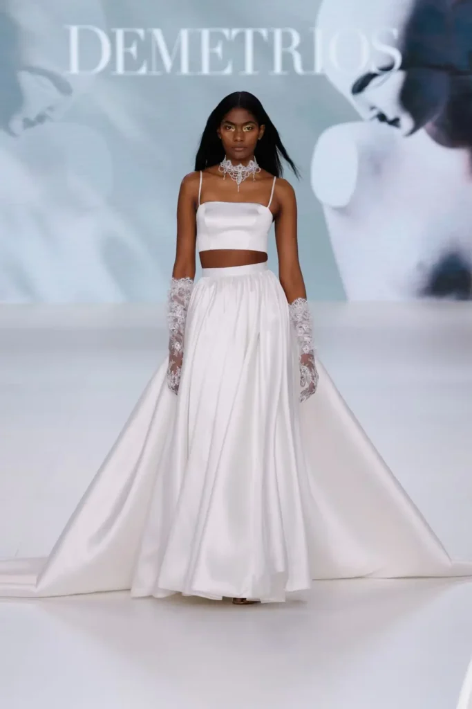 Two-piece bridal look featuring a satin crop top, full flowing skirt, lace gloves, and crystal choker necklace
