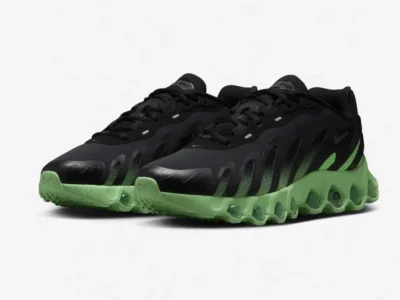 Three-quarter view of a pair of Nike Air Max Dn8 sneakers in black and lime green. The aerodynamic upper, layered textures, and exposed air cushioning emphasize the model’s performance-inspired, futuristic design