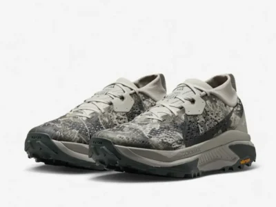 Angled view of the Nike ACG Zegama Trail pair in Spruce Fog/Sea Glass/Black Spruce, displaying the low-profile silhouette, reinforced overlays, and balanced cushioning stack perfect for all-conditions performance