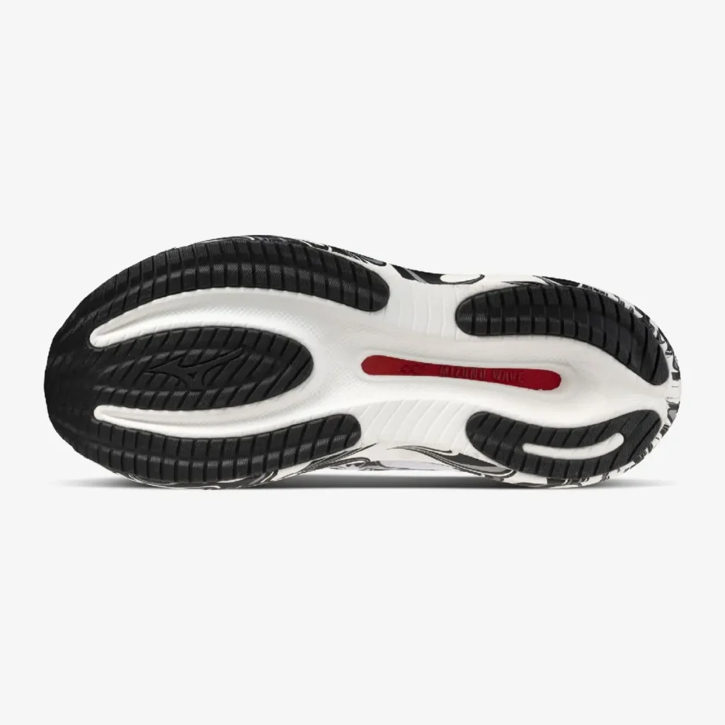 Outsole view of the Mizuno Wave Rider 30 “Ride the Wave” featuring durable black rubber traction pods, a sculpted white sole unit, and a red Mizuno Wave plate view through the center channel