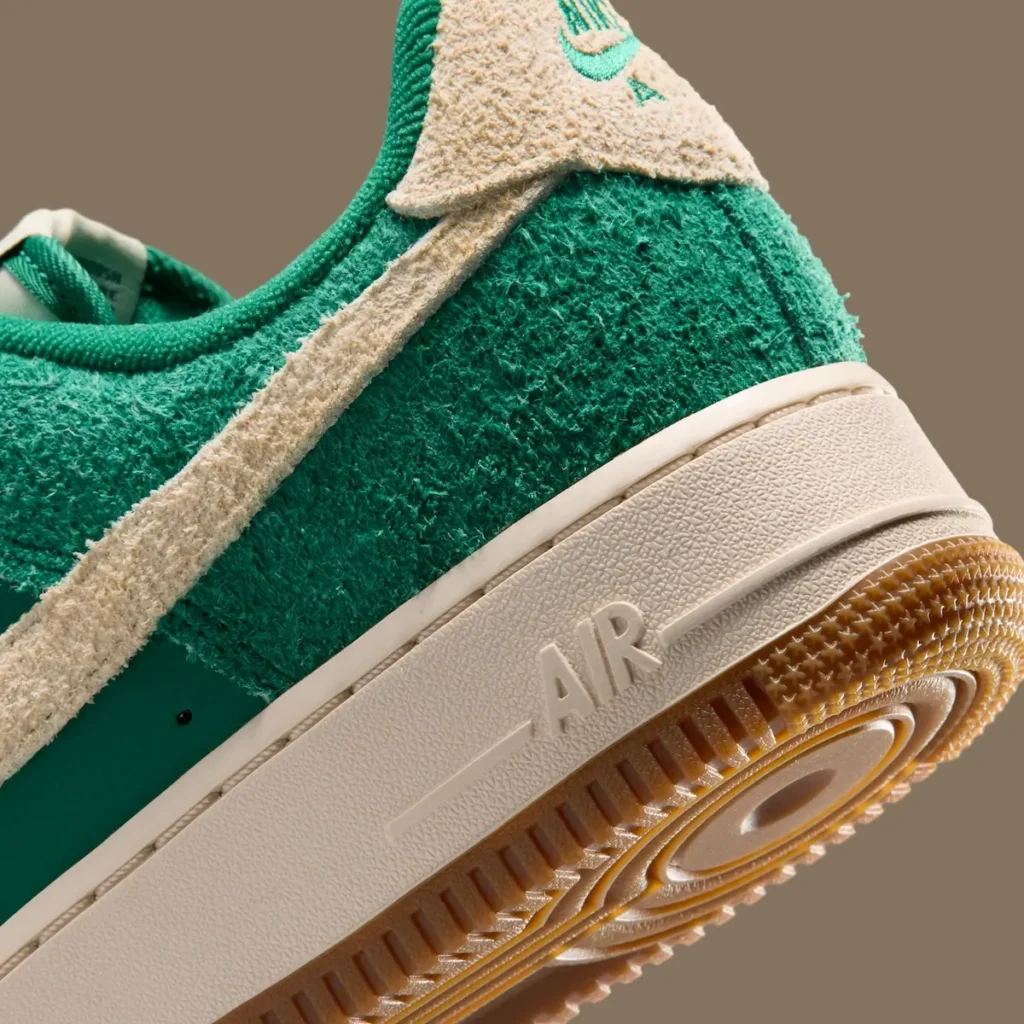 Macro shot of the heel and midsole captures the hairy suede texture in sharp detail. The embossed AIR branding on the midsole and translucent gum outsole underscore the shoe’s premium finish and classic Air Force 1 design lang