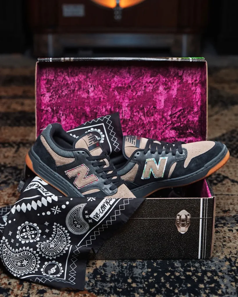 The No-Comply x New Balance Numeric 480 is presented inside a special-edition storage box lined with vibrant burgundy velvet. A paisley bandana and the collaborative sneakers complete the premium packaging display