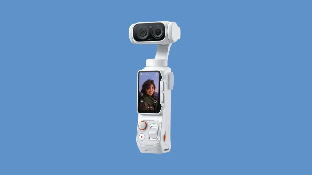White edition Insta360 handheld camera shown at an angle against a soft blue background, showcasing its dual-lens camera module, touchscreen interface, and streamlined portable form factor