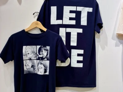 Navy blue Beatles T-shirt featuring four black-and-white portrait panels on the front and oversized “LET IT BE” typography across the back