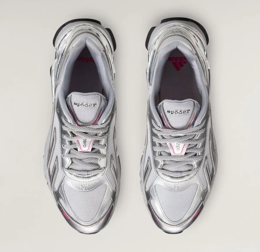 Top-down view of the Sp5der x adidas F50 Formotion “Silver Metallic” shoe. The pair features silver synthetic overlays, light grey mesh uppers, chrome-like Formotion heel structures, subtle pink accents, grey laces, and dual adidas and Sp5der branding on the tongue