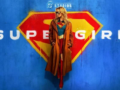 Milly Alcock channels rebellious cool as Supergirl in the official 2026 poster. Trench coat over the iconic suit against a graffiti S-shield — James Gunn’s Woman of Tomorrow lands June 26. Pure attitude