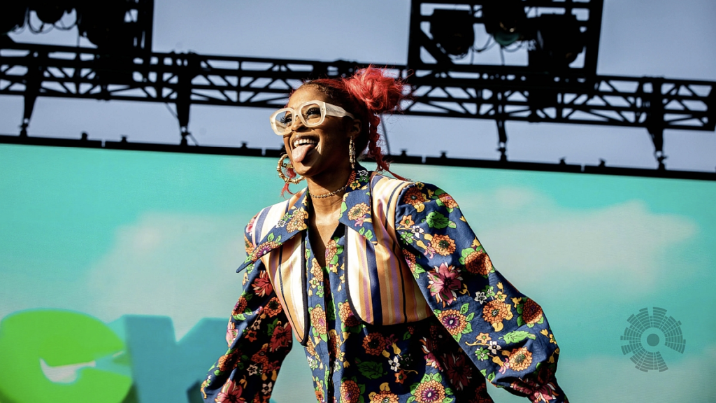 Tierra Whack live on stage in flow maximalist outfit and red hair during high-energy performance – clean editorial image from WAX PAPER era
