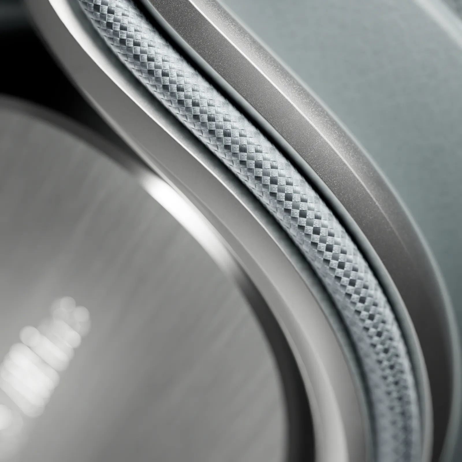 Macro detail of the headphone earcup, revealing a woven-texture trim ring, brushed metal accents, and refined craft around the speaker housing