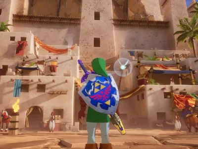 Link stands in the center of a sunlit desert fortress inspired by Gerudo Valley, holding the Hylian Shield and Master Sword while Navi hovers beside him. The scene features towering sandstone architecture, colorful market fabrics, palm trees, torch-lit entrances, and NPCs moving through a bustling oasis settlement in a detailed Unreal Engine 5 fan recreation of The Legend of Zelda: Ocarina of Time