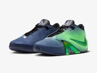 Three-quarter front view of a pair of Nike Ja 3 basketball shoes showing the contrasting lateral and medial sides, gradient uppers, metallic accents, and low-cut performance design