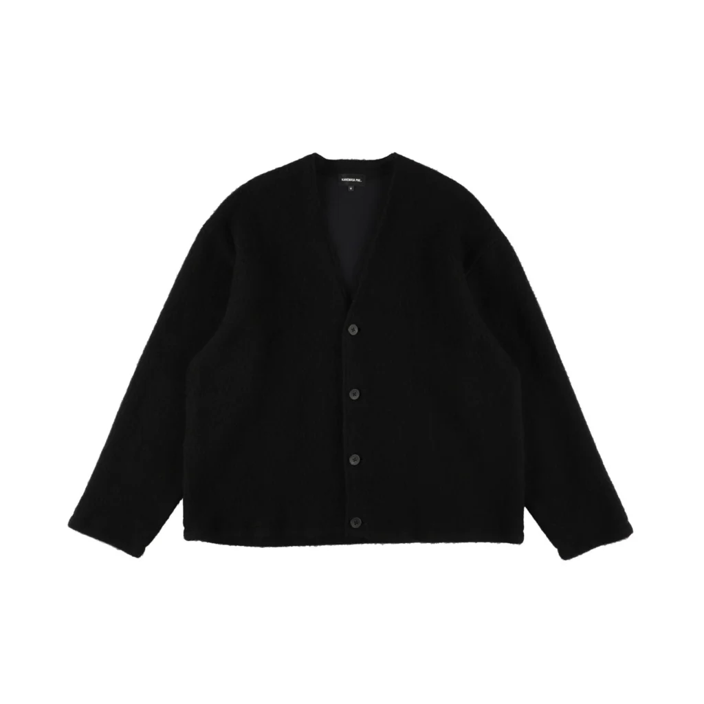 Black brushed knit cardigan featuring a soft textured finish, deep V-neckline, front button closure, dropped shoulders, long sleeves, and a relaxed oversized silhouette with minimalist style