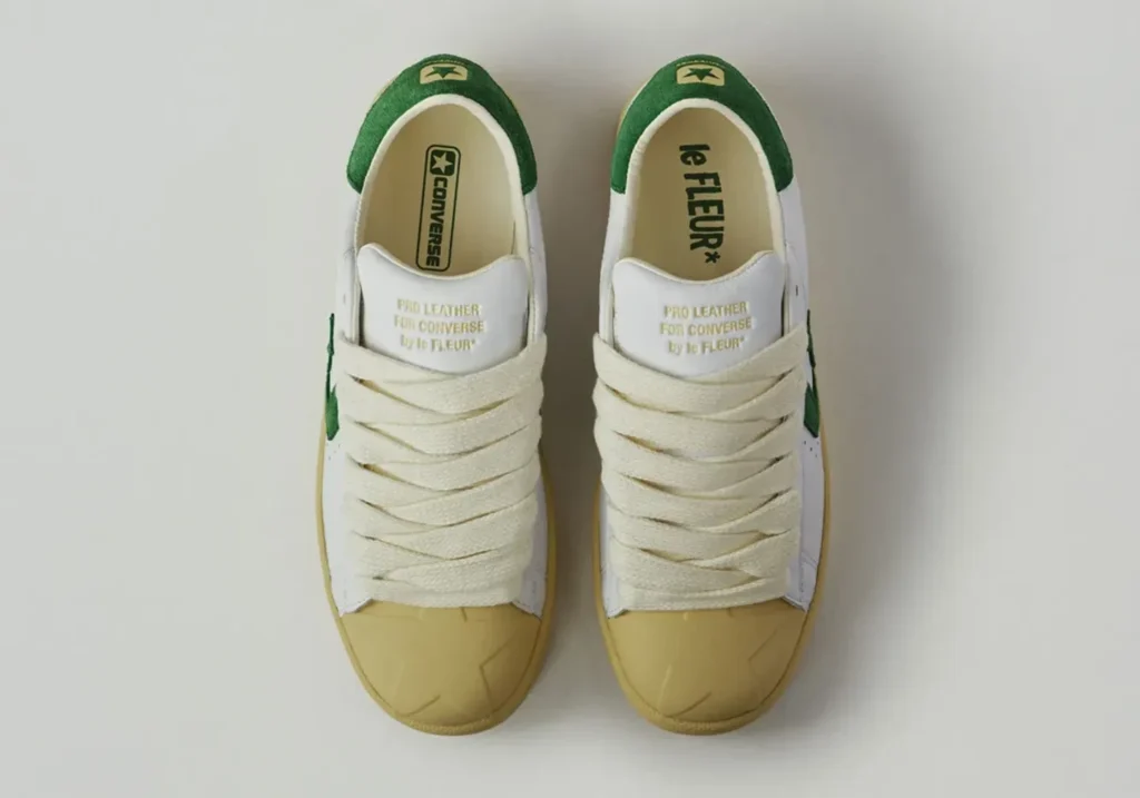 Top-down view of the white Converse Pro Leather by le FLEUR* with green heel tab, oversized cream rope laces, cream rubber toe cap, and co-branded insole
